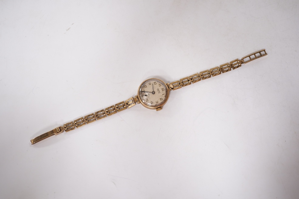 A lady's 9ct gold Vertex manual wind wrist watch, with Arabic dial and subsidiary seconds, on a 9ct gold associated bracelet, gross weight 15 grams. Condition - poor